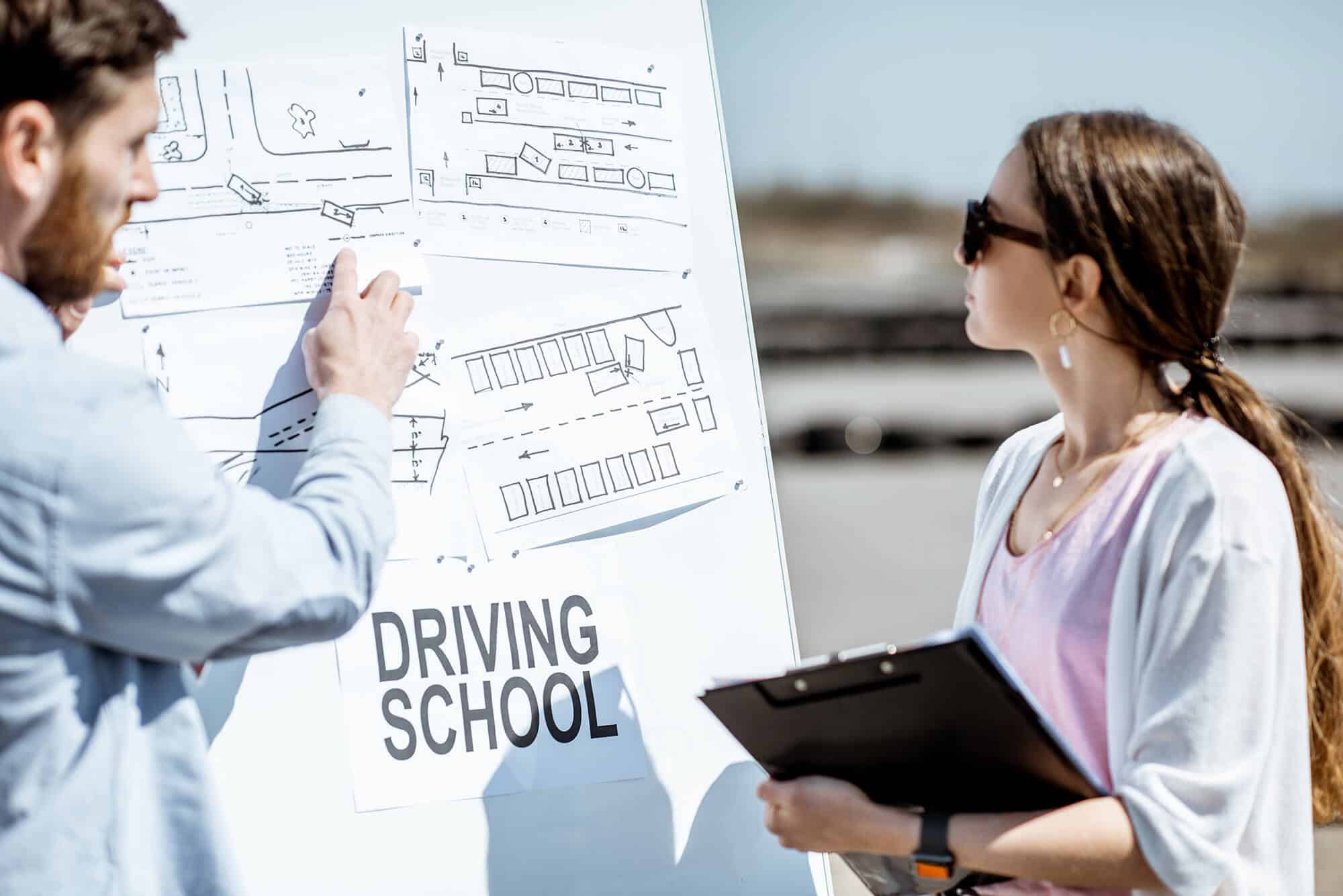 Instructor explaining traffic rules to a student at Rafael Driving School